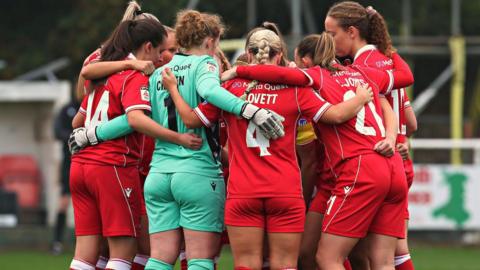 Wrexham Women in a team huddle before a game 