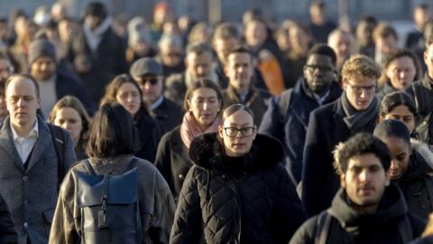 Commuters cross London Bridge in London, UK, on Monday, Feb. 17, 2025.