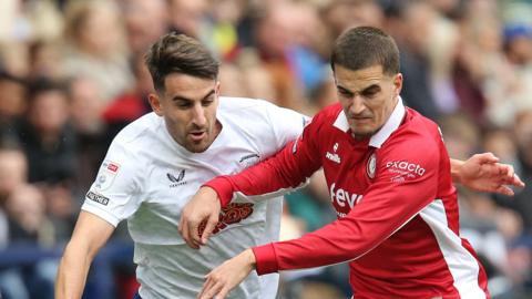 Pol Valentin and Anis Mehmeti battle for the ball