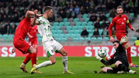 Raul Florucz sees his shot saved by outstretched Larne keeper Rohan Ferguson