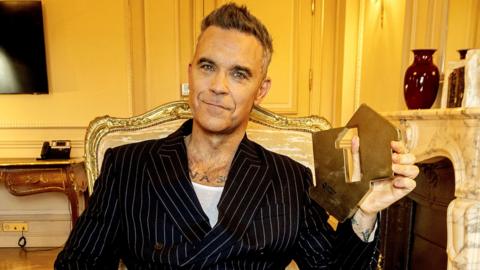 Robbie Williams celebrates making history