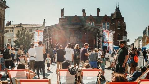 A crown in front of a BTS stage on the Cornhill in Ipswich

