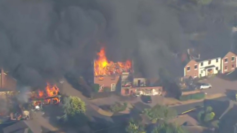Fire raging in a house.
