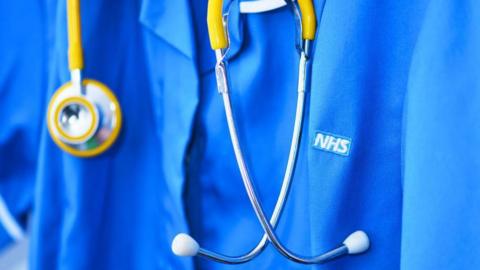 A stock image of an NHS professional wearing a stethoscope. 