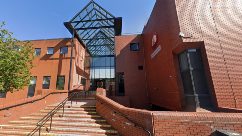 A general view of Leicester Crown Court, a red-brick building with glass roof