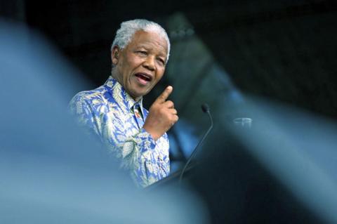 Nelson Mandela giving a speech at a podium
