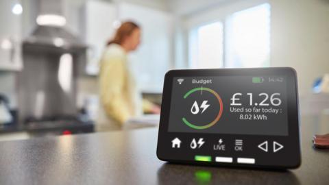 A smart electricity meter sitting on a kitchen countertop. 