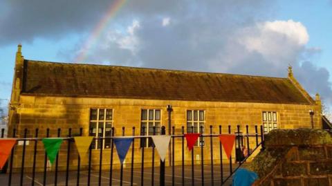 Rainbow in sky behind Goosnargh Oliverson's Church of England Primary School