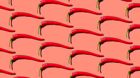 Red chilli peppers isolated on orange background
