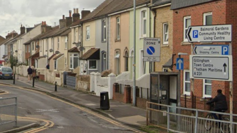 A google maps image of a street with signs pointing towards Gillingham town centre.