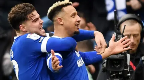 Callum Robinson of Cardiff City celebrates scoring his second goal of the match with Ollie Tanner (L)