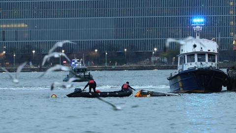 Crews work to remove a crashed helicopter from the Hudson River on April 10, 2025 in Jersey City, New Jersey. Six people are dead after the sightseeing helicopter, believed to be carrying a family of tourists from Spain, crashed into the Hudson River off Lower Manhattan this afternoon