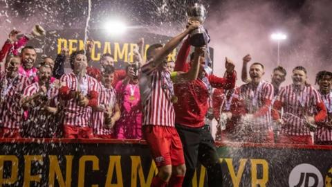 Holywell players celebrate winning the JD Cymru North