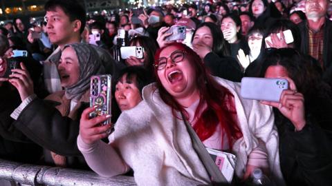 BTS fans react as they watch the comeback concert of K-pop boy group BTS