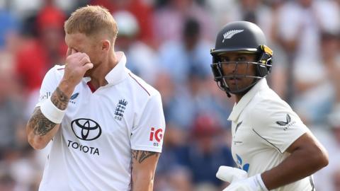 England captain Ben Stokes (left) grimaces as New Zealand batter Rachin Ravindra (right) runs past