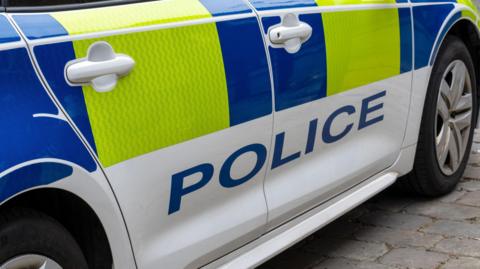 A stock image of the side of a police car