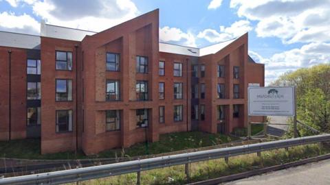 Wilford View Care Home in Nottingham. A red-brick, three-storey building with large windows. 