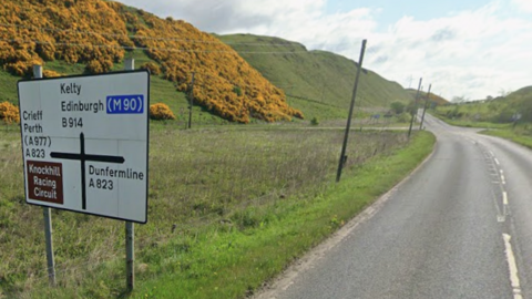 A Google view of a road sign next to a country road