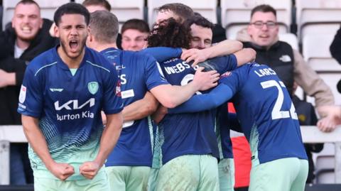 Burton Albion celebrate their winner against Lincoln City