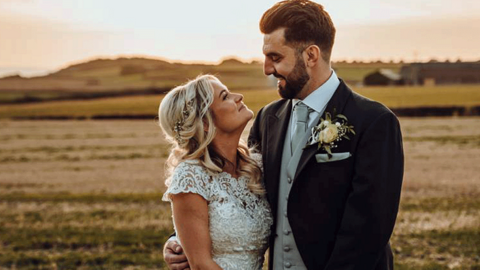 Ellie and Owain James pose for a wedding photo