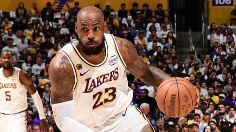 LeBron James dribbling basketball in a game for the LA Lakers