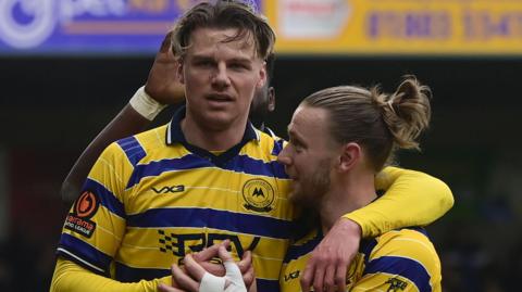 Cody Cooke celebrates scoring for Torquay United