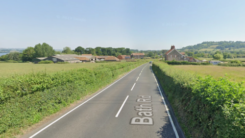 Bath Road, which runs between hedges towards a village.