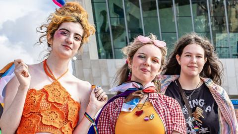 People wearing bright clothes and enjoying Liverpool Pride