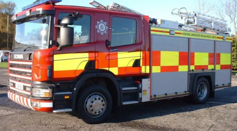 A red fire engine on tarmac with Hereford and Worcester Fire and Rescue Service written on the side