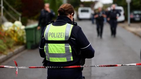 German police officers seal of the area where Herdecke's Mayor Iris Stalzer was found with stab wounds. Photo: 7 October 2025