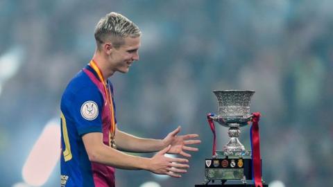 Dani Olmo with the Super Cup trophy