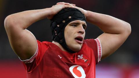 Dafydd Jenkins in action for Wales with his hands on his head