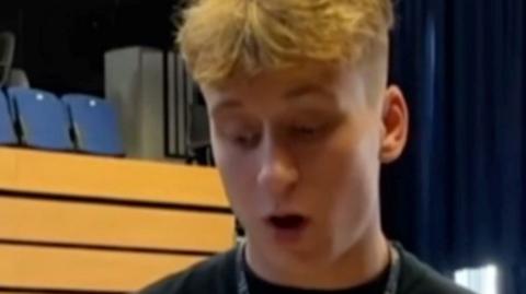 Blonde teenage boy  looking surprised