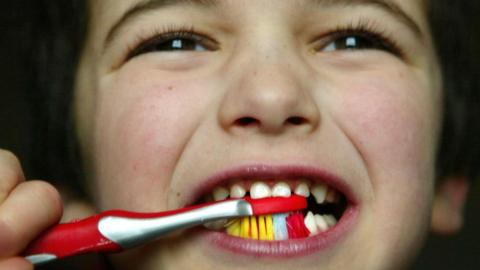 Child brushing teeth