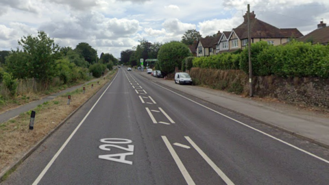 The A20 London Road in West Malling - a long , straight road with only one car in the distance.