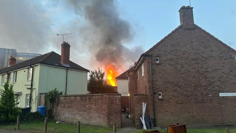 Flames and smoke pour from a two-storey house that is on fire in Portman Road in Ipswich