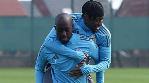 Anthony Elanga on the back of Yoanne Wissa in training for Newcastle