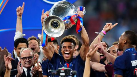 Desire Doue lifts Champions League trophy
