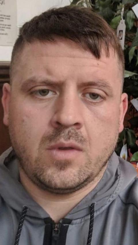 A man in a grey hoodie