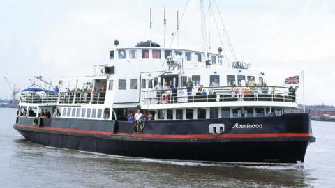 Mersey Ferry on the River Mersey with passengers onboard.