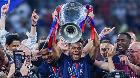 Desire Doue lifts the Champions League trophy