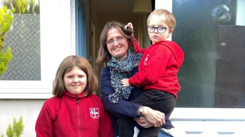 Kidderminster mother of two Helen James poses for a photo outside her house with her two children: Lillian, 9, and Philip, 5. 