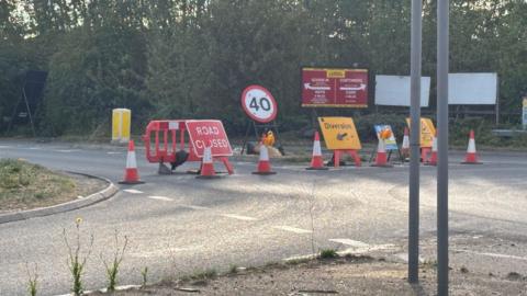 Road Closed, 40mph and Diversion signs are placed across a road junction.