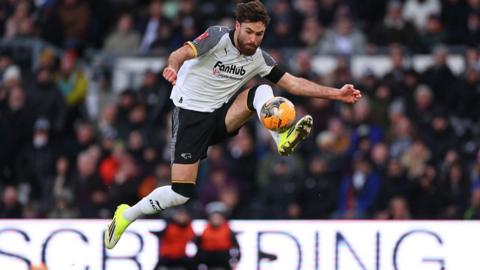 Derby's Ben Brereton Diaz jumps to control the ball