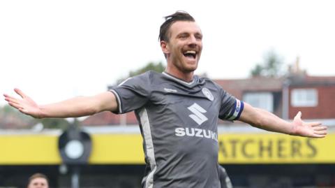 Alex Gilbey celebrates a goal for MK Dons
