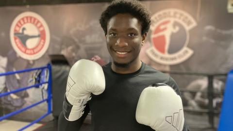 Divine in the gym with boxing gloves on