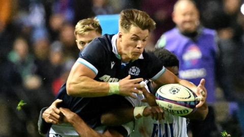 Huw Jones trying to evade Fiji tacklers