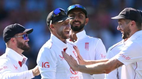 England players congratulate Joe Root (centre) on taking a catch