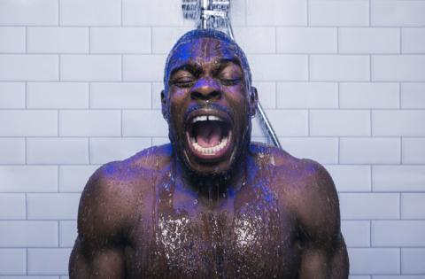 Gloucester rugby player Christian Wade grimaces as he stands under a cold shower