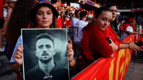 Fans pay tribute and respect to Diogo Jota at a football match
